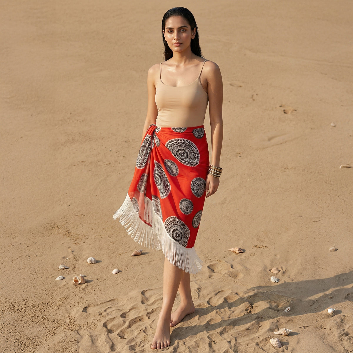 Red short sarong in a geometric circle print, tied at the hip with a fringed edge
