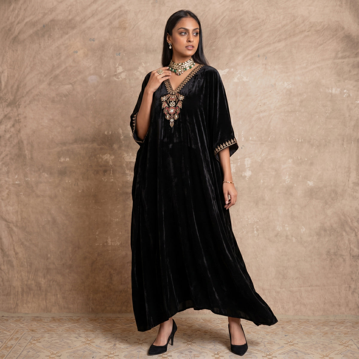 Black silk velvet full-length kaftan with a gold embroidered V-neck placket and gold-trimmed cuffs