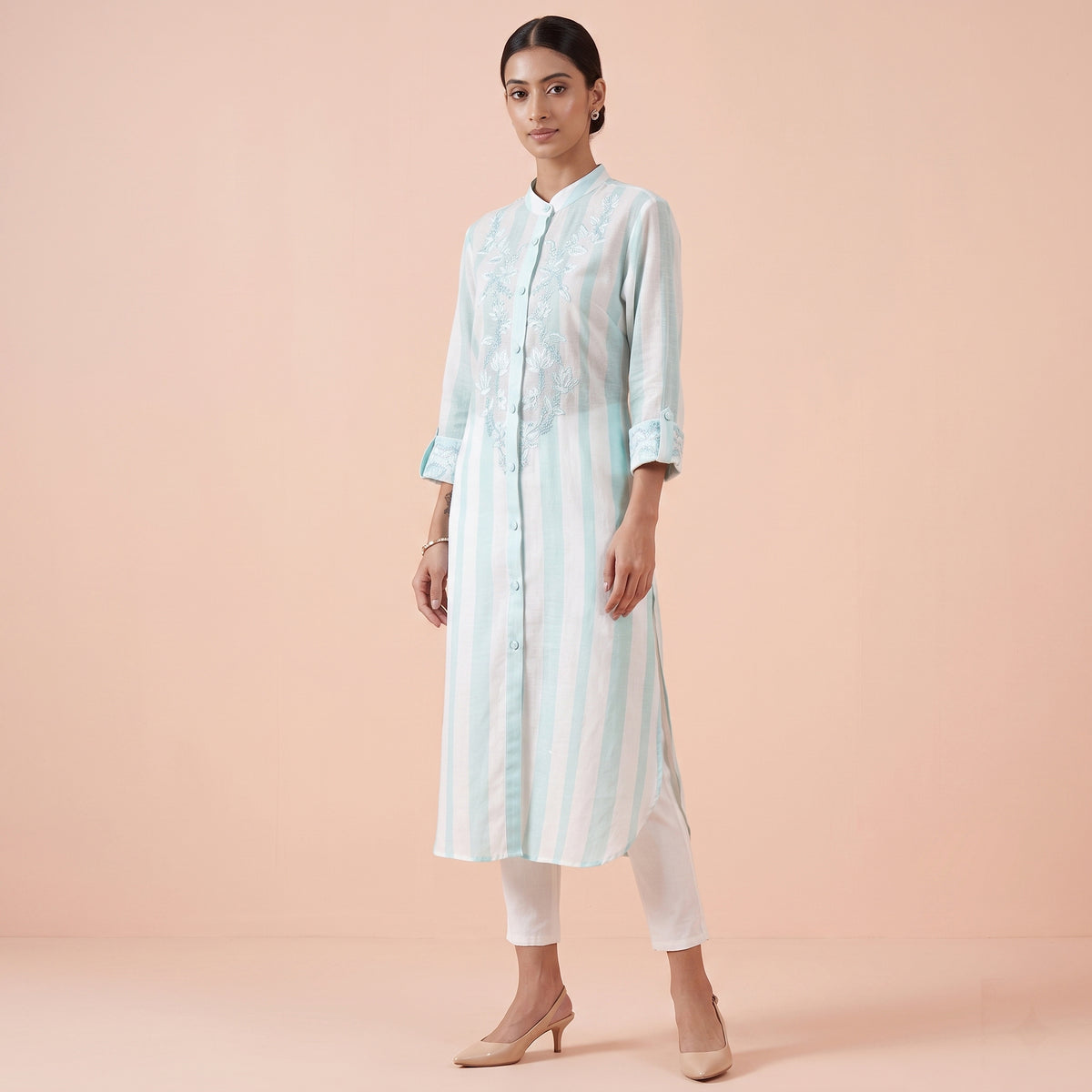 White kurta with fine green stripes and embroidery down the buttoned placket, mid-calf length
