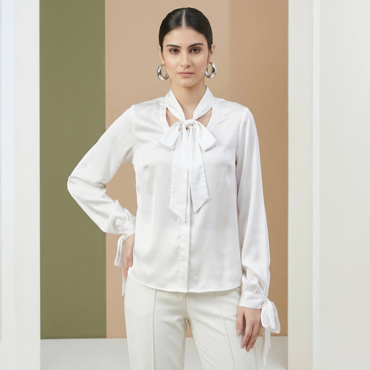 White satin shirt with a pussy-bow neck tie and cuffs that tie at the wrist