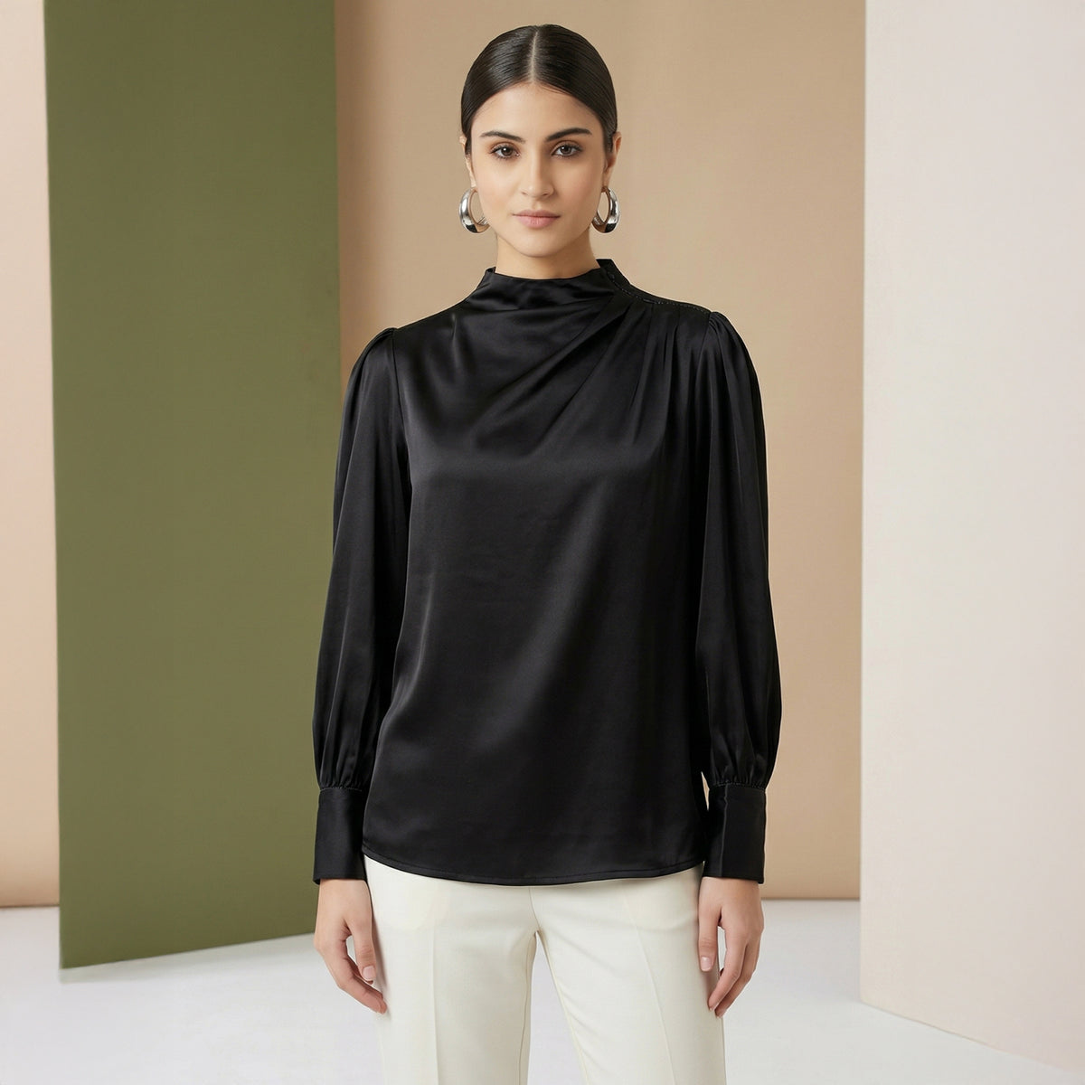 Black satin blouse with a high draped neck, pleated shoulders and full blouson sleeves
